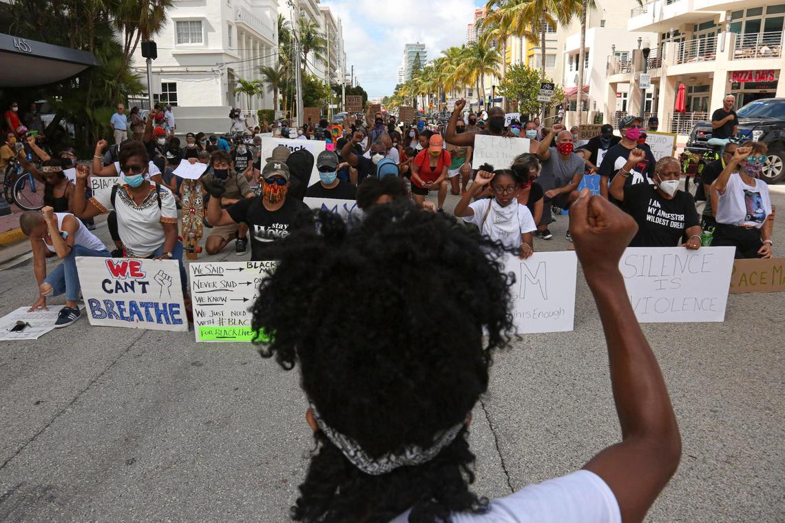 Bridjette Hoilett-Green kneels for eight minutes on 5th Street and Ocean Drive as she faces a crowd of protesters also kneeling during a demonstration to Support BLM and Anti-Racism in Miami Beach, Florida, Sunday, June 14, 2020.