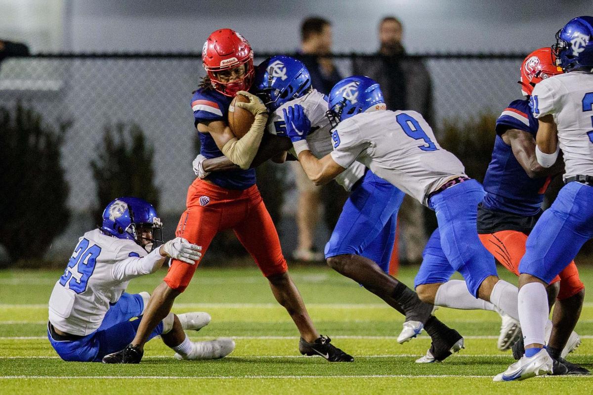 Champagnat’s Jaylin Terzado (6) tries to fight off defenders as he makes his way down the field. Trinity Christian leads Champagnat 14-7 at the half of the Class 2A State Championship game at Gene Cox on Thursday, Dec. 9, 2021.