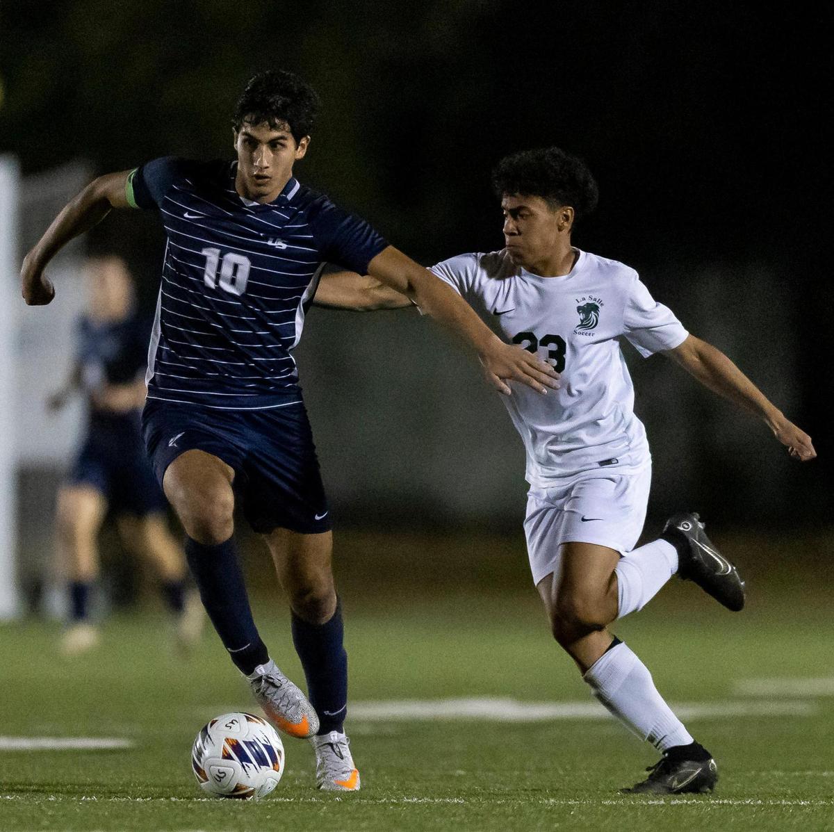 NSU’s Rafael Guerra (10) dribbles with the ball as La Salle’s Kevin Ceballos (23) defends during the second half of a Region 4-3A final at NSU University School on Wednesday, Feb. 15, 2023.