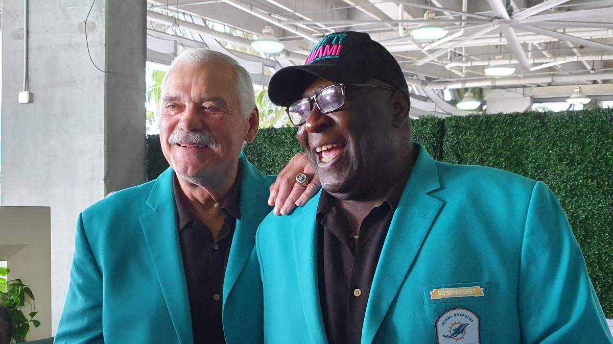 Former Miami Dolphins Larry Csonka and Larry Little smile at a pre-game reception before the Dolphins play the Cincinnati Bengals on Sunday, Dec. 22, 2019, at Hard Rock Stadium. The Dolphins honored their undefeated 1972 team at halftime of the game.