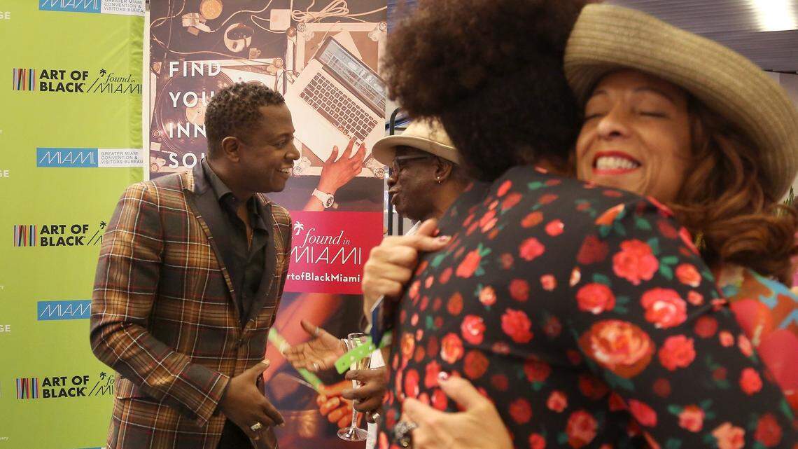 Artist Sanford Biggers, left, greets attendees during an Art of Black Miami event inside the Brightline Central Station in Overtown on Nov. 8. Art of Black Miami is organized by the Greater Miami Convention & Visitors Bureau.