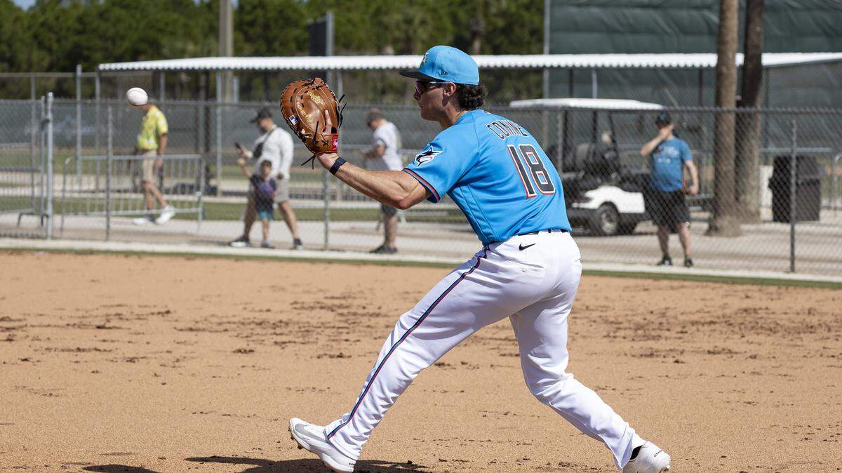 Miami Marlins left fielder Griffin Conine (18) catches the ball during the team’s first full-squad spring training workout at Roger Dean Stadium on Monday, Feb. 16, 2026, in Jupiter, Fla.