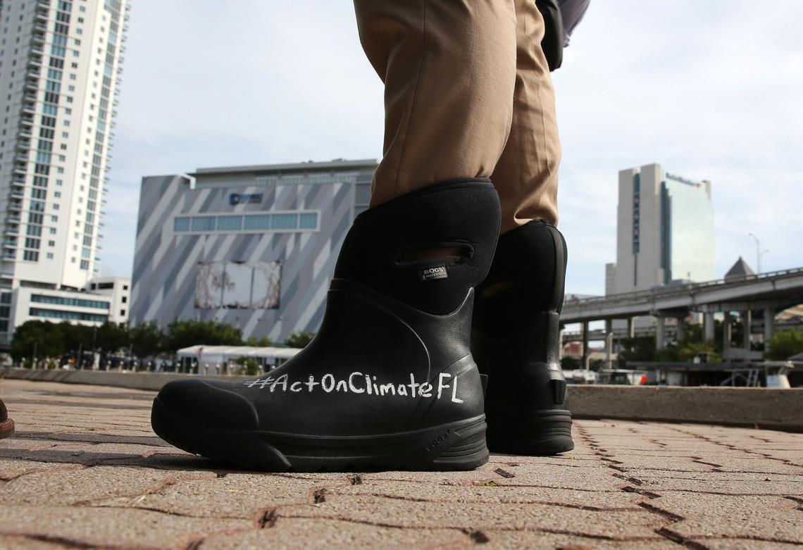 Miami Sen. José Javier Rodríguez wears his message about climate change on his rain boots as he inspects Jose Marti Park in Little Havana for signs of flooding during the morning king tide on Oct. 9, 2018. The park and other areas in Miami didn’t see remarkable flooding during this king tide.
