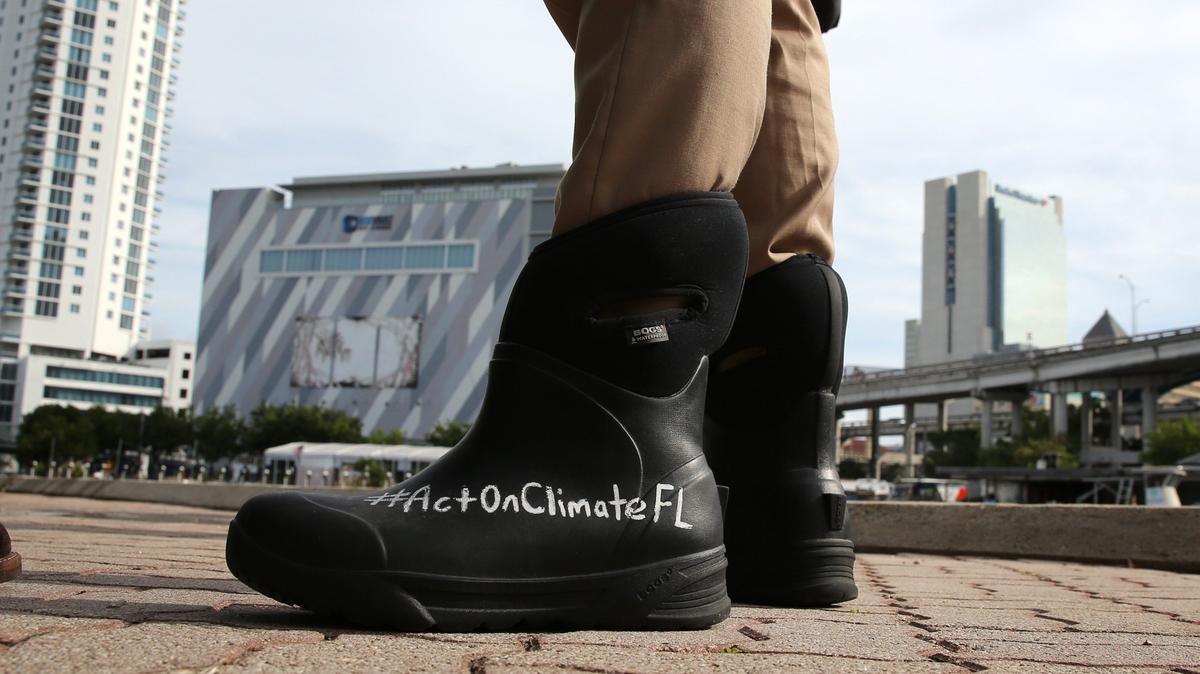 Miami Sen. José Javier Rodríguez wears his message about climate change on his rain boots as he inspects Jose Marti Park in Little Havana for signs of flooding during the morning King Tide on Oct. 9, 2018. The park and other areas in Miami didn’t see remarkable flooding during this King Tide.