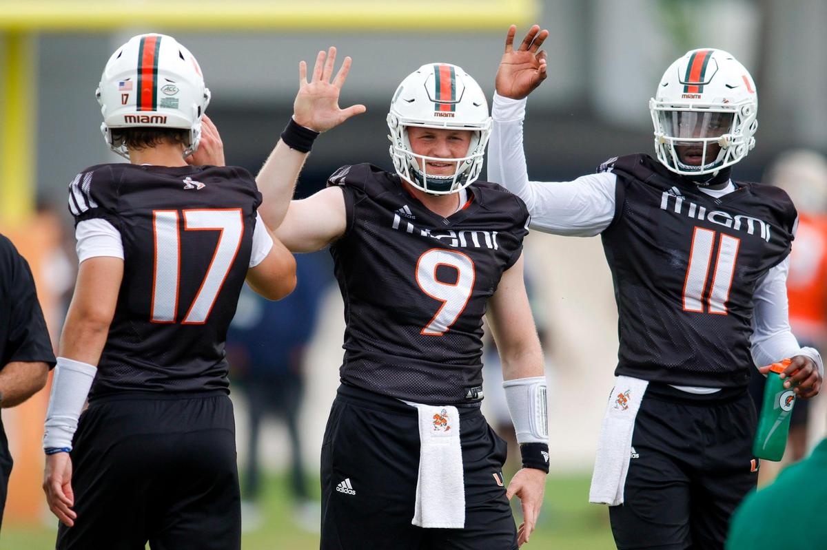 Miami Hurricanes quarterback Tyler Van Dyke (9) celebrates with quarterback Emory Williams (17) and quarterback Jacurri Brown (11) during spring practice at the University of Miami in Coral Gables, Florida, Saturday, March 4, 2023.