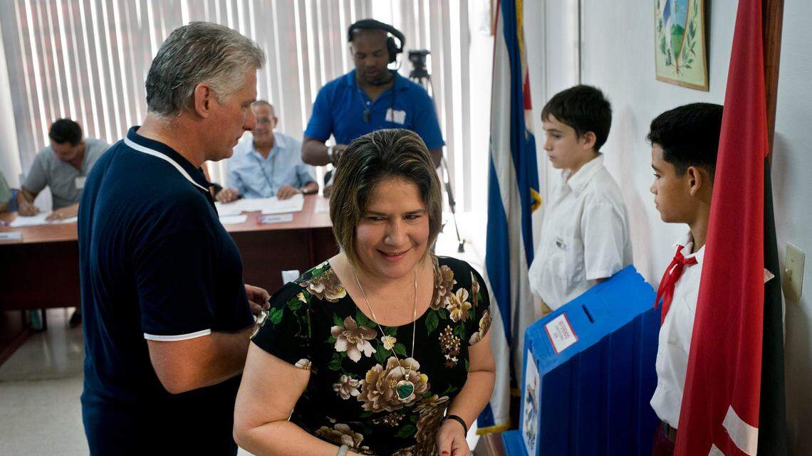 Cuba’s President Miguel Diaz-Canel prepares to vote after his wife Lis Cuesta during a referendum to approve or reject a new constitution. The constitutional reforms maintain Cuba’s single-party political system and centrally planned economy while recognizing private property and small businesses.