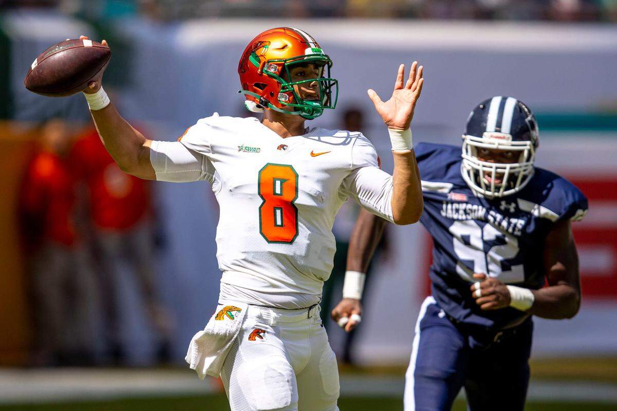 Florida A&M University quarterback Jeremy Moussa (8) throws the ball while chased by Jackson State University defensive lineman Justin Ragin (92) during the first quarter of the Orange Blossom Classic at Hard Rock Stadium in Miami Gardens, Florida, Sunday, September 4, 2022.
