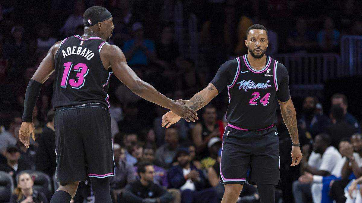 Miami Heat center Bam Adebayo (13) and guard Norman Powell (24) celebrate after scoring against the Golden State Warriors in the second half of their NBA game at Kaseya Center on Nov. 19, 2025, in Miami.