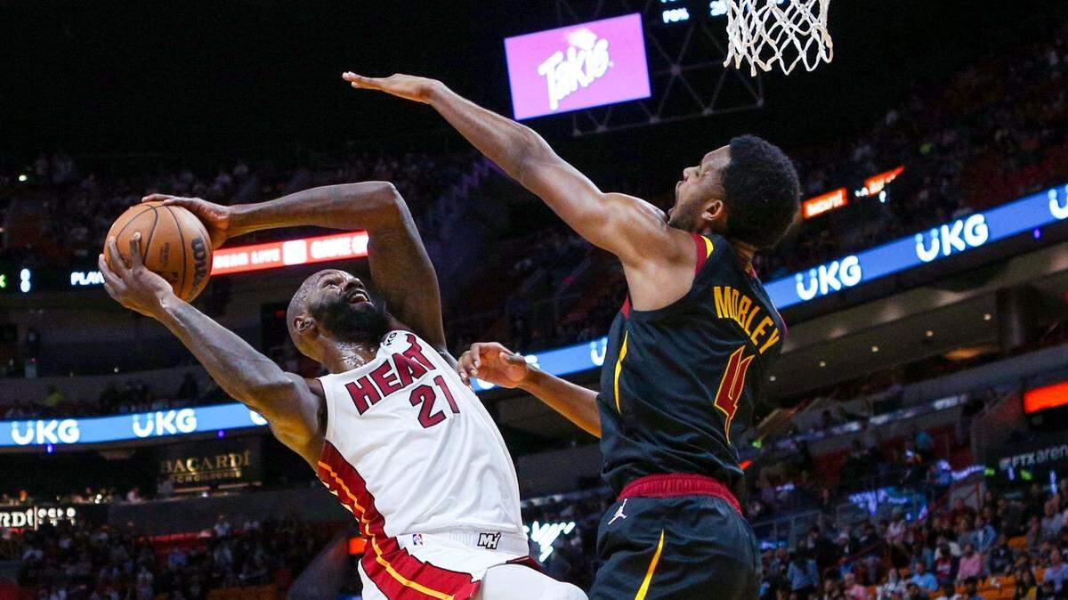 Miami Heat center Dewayne Dedmon (21) attempts a shot while guarded by Cleveland Cavaliers center Evan Mobley (4) during the first quarter of an NBA game at FTX Arena in Downtown Miami, Florida, on Wednesday, December 1, 2021.