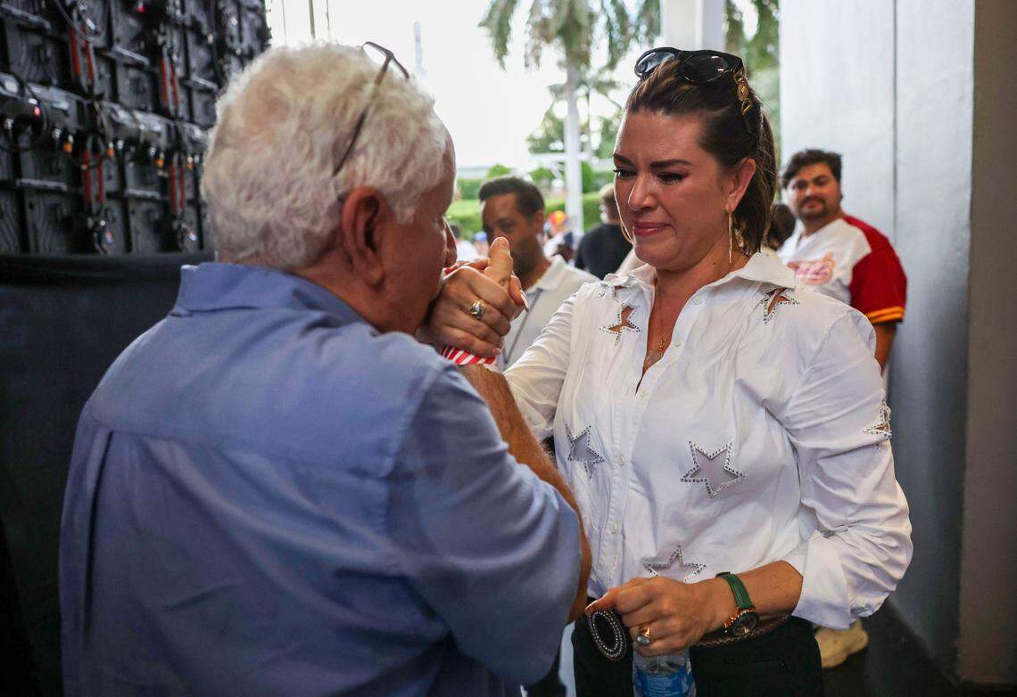 Miami, Florida, August 17, 2024 - Venezuelan screen writer Leonardo Machado, left, greets former Ms Universe Alicia Machado, right, back stage during the rally at the FPL Solar Amphitheater Auditorium in downtown Miami.