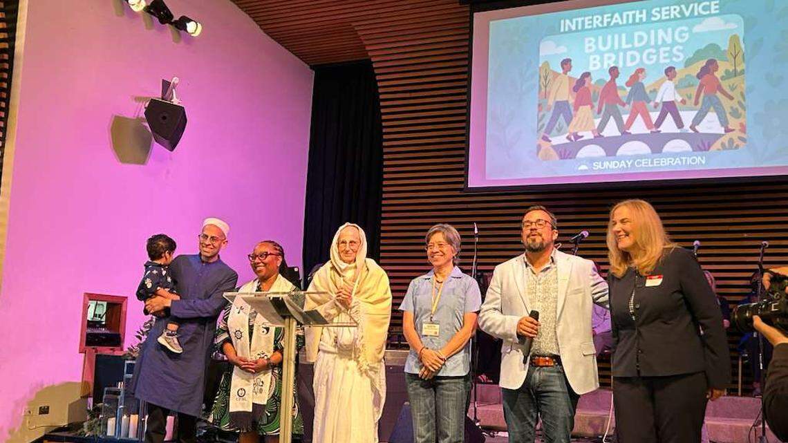 Islamic scholar Iqbal Akhtar (far left), Rev. Tawnicia Ferguson, spiritual teacher Syamarani Dasi, Judith Echeverria, Rev. Rev. Juan del Hierro and Rabbi Jamie Aklepi gather on stage for an interfaith service and potluck