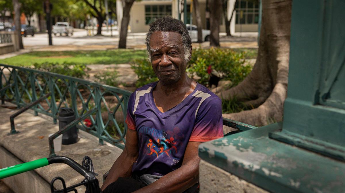 Ishmael Burch Jr., relaxes in the shade during the heat of the day on Monday, July 17, 2023, at the park across from Government Center in downtown Miami. Burch said he finds it hard to stay hydrated but that he can fill up his water bottle at the library nearby.