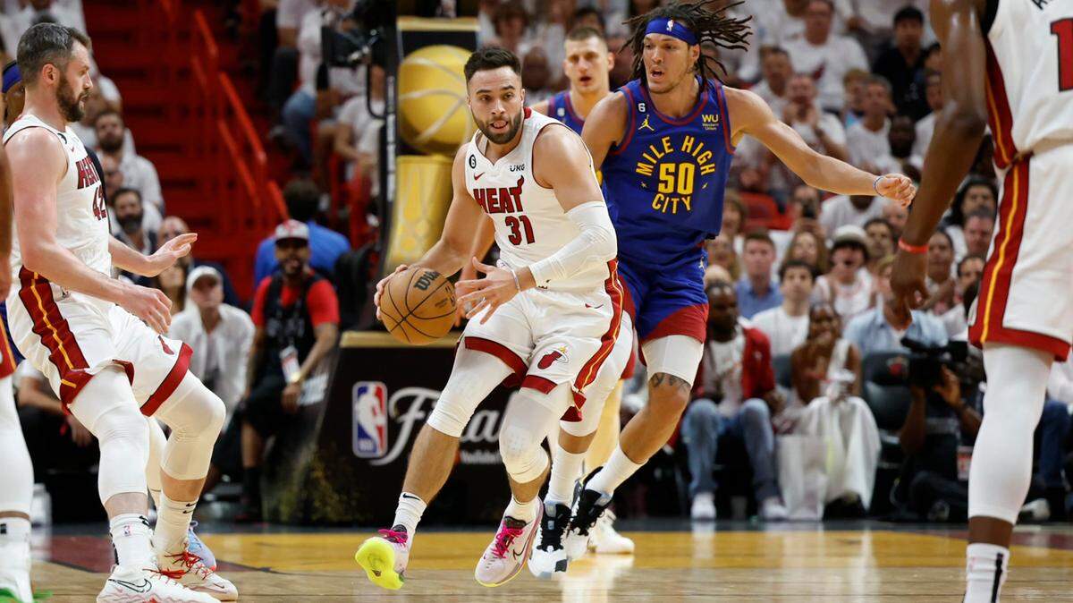 Miami Heat guard Max Strus (31) controls the ball as Denver Nuggets forward Aaron Gordon (50) gives chase during the first half of Game 3 of the NBA Finals at the Kaseya Center in Miami on Wednesday, June 7, 2023.