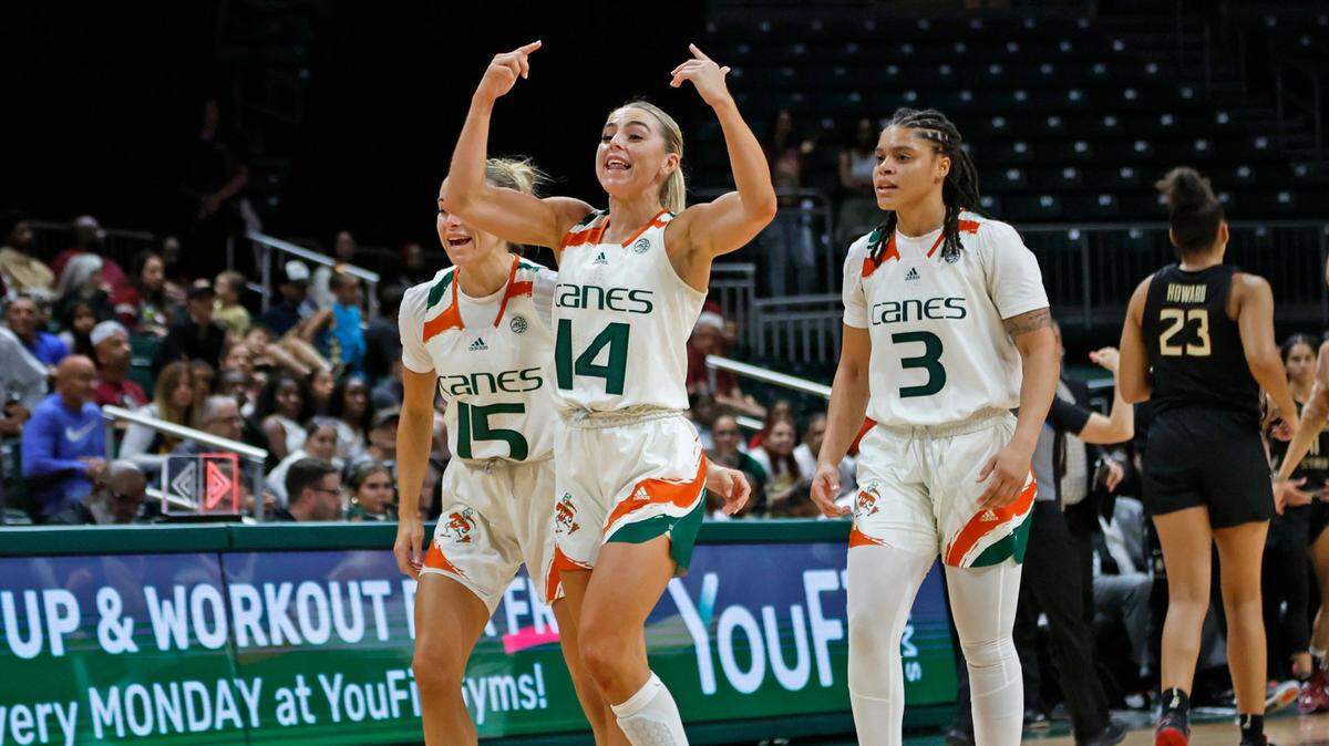 Miami Hurricanes guard Haley Cavinder (14) celebrates on the court with guard Hanna Cavinder (15) and forward Destiny Harden (3) as the Canes lead against the Florida State Seminoles during the regular season. They advanced to their first Sweet 16 in 31 years and will face Villanova on Friday.