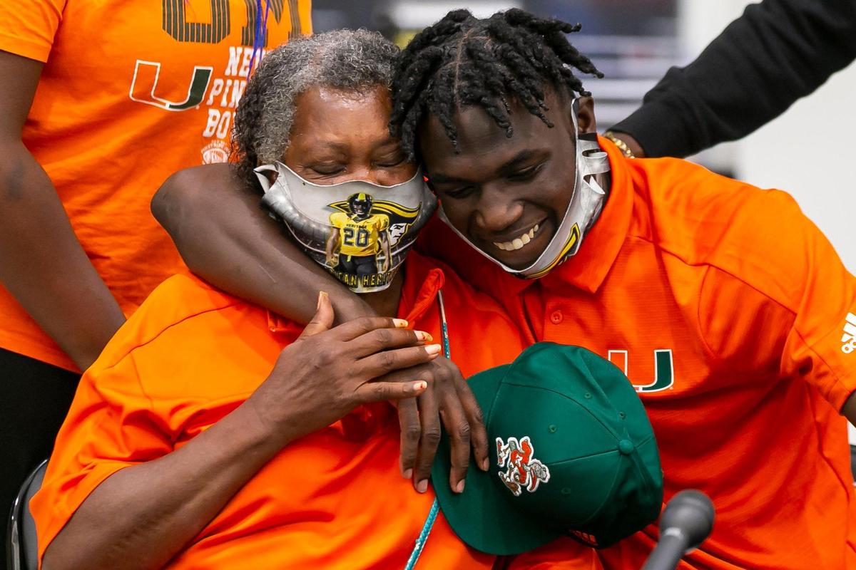 James Williams hugs his grandmother, Ira Williams, after signing with the University of Miami during National Signing Day at American Heritage School in Plantation, Florida on Wednesday, December 16, 2020.