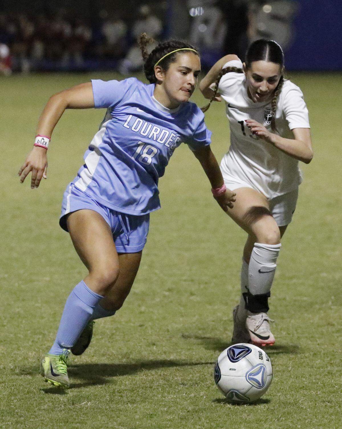 Pembroke Pines Charter Amanda Fernandez (on the right) challenges for the ball Lourdes Academy Cecilia Rodriguez (18) during the Region 4-5A final girls soccer match on Tuesday, February 17, 2026 at Miami-Dade College Kendal campus. Andrew Uloza / for Miami Herald