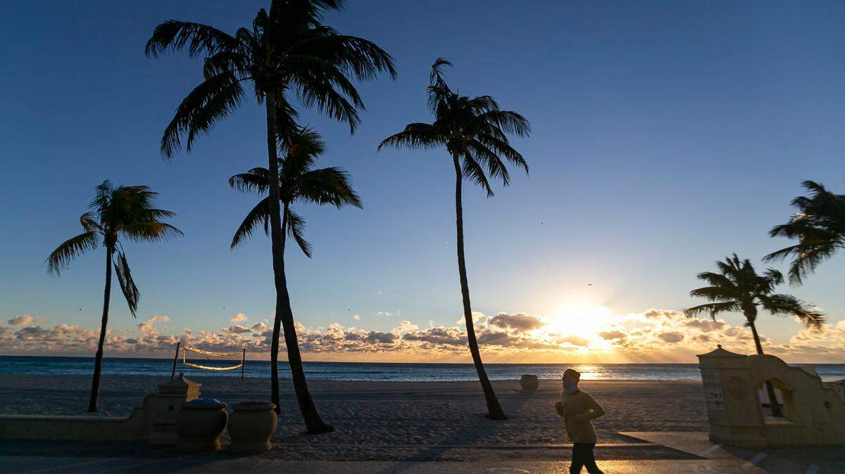 A runner makes her way down the Hollywood Beach Broadwalk as temperatures dip into the mid-40s on Saturday, Jan. 14, 2023, in Hollywood, Florida.