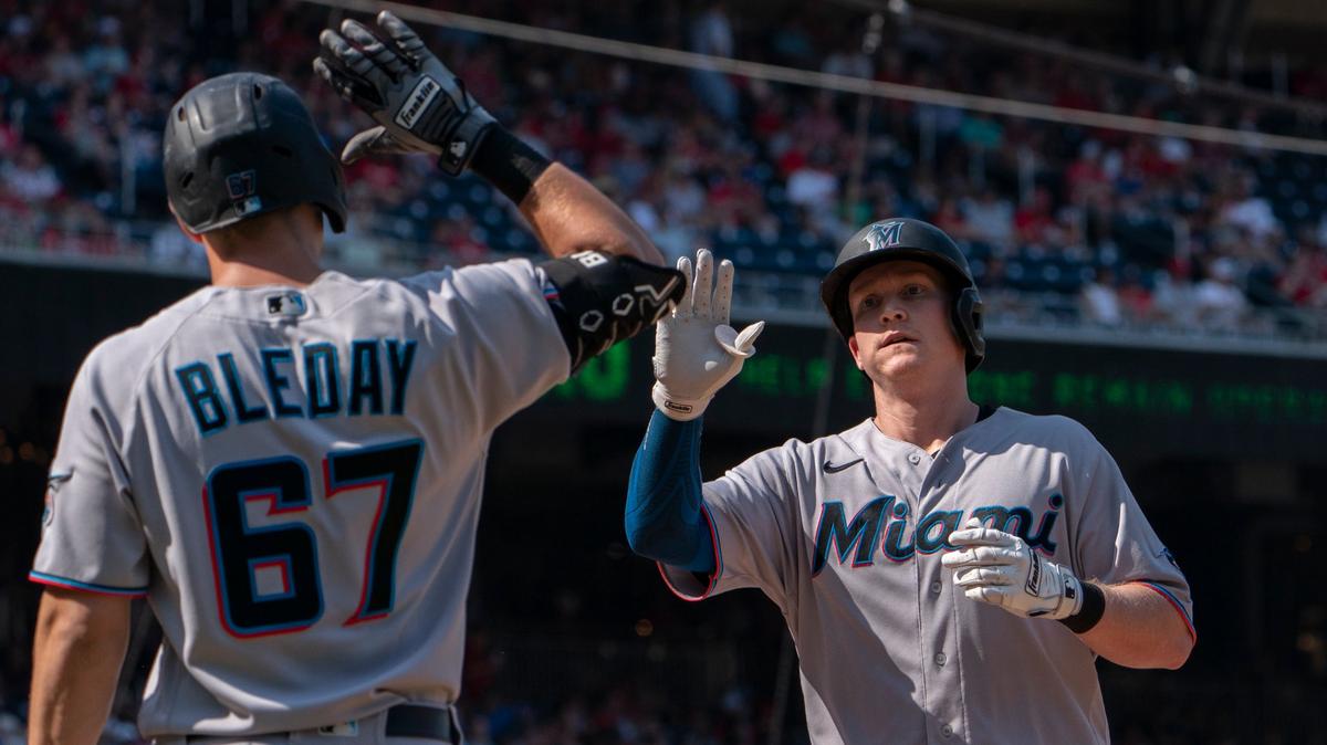 Miami Marlins Garrett Cooper, right, is congratulated by teammate JJ Bleday (67) after hitting a home run during the sixth inning of a baseball game against the Washington Nationals in Washington, Sunday, Sept. 18, 2022. (AP Photo/Manuel Balce Ceneta)