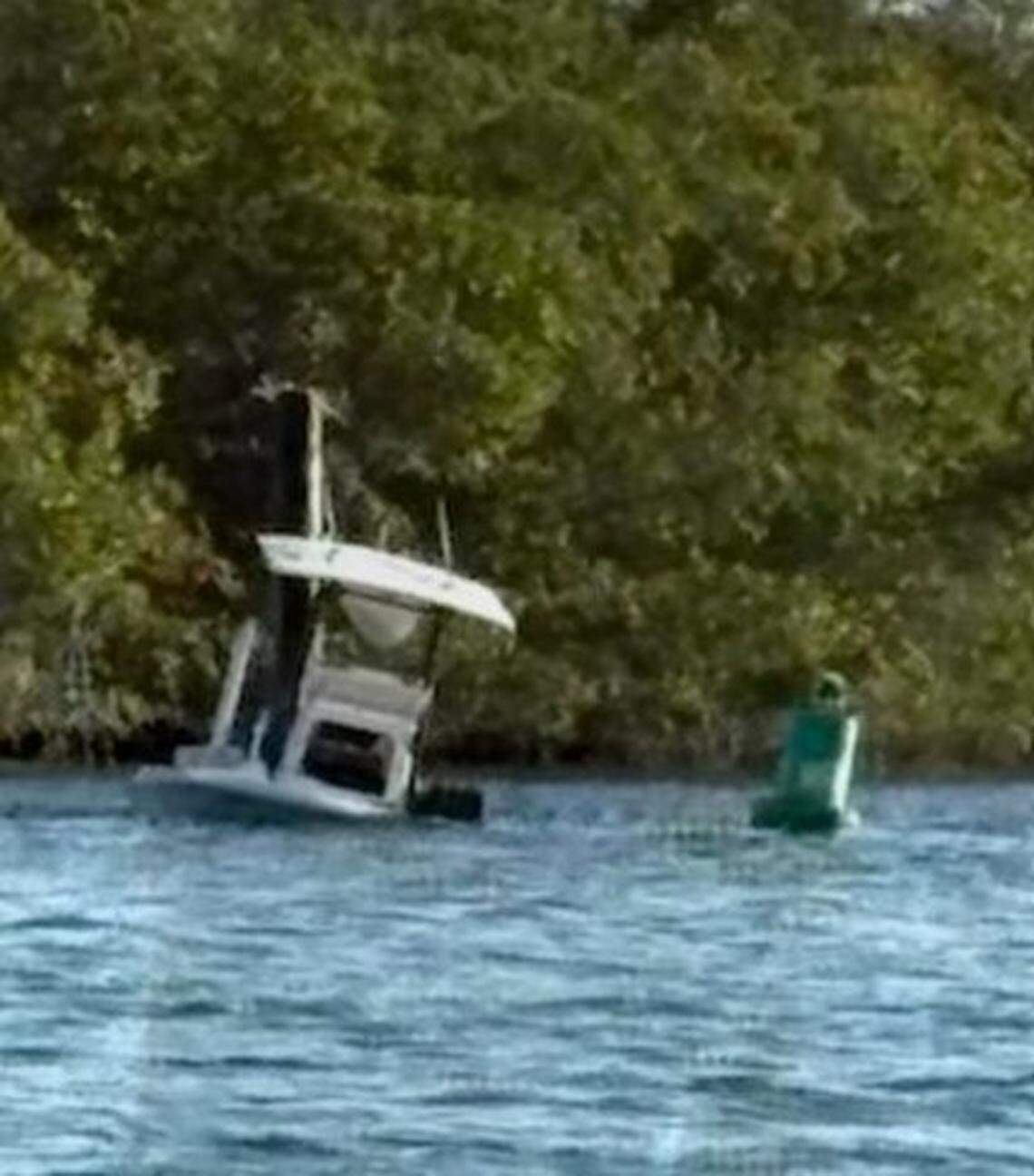 A center-console boat partially sinks off Tavernier in the Florida Keys on Friday, Feb. 20, 2026. Monroe County Fire Rescue said six people on board were ejected after the boat hit a channel marker.