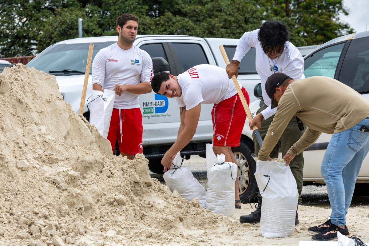 Volunteers and members of the public fill up sandbags at Tropical Park in preparation for Hurricane Milton on Tuesday, October 8, 2024, in Miami, Fla.