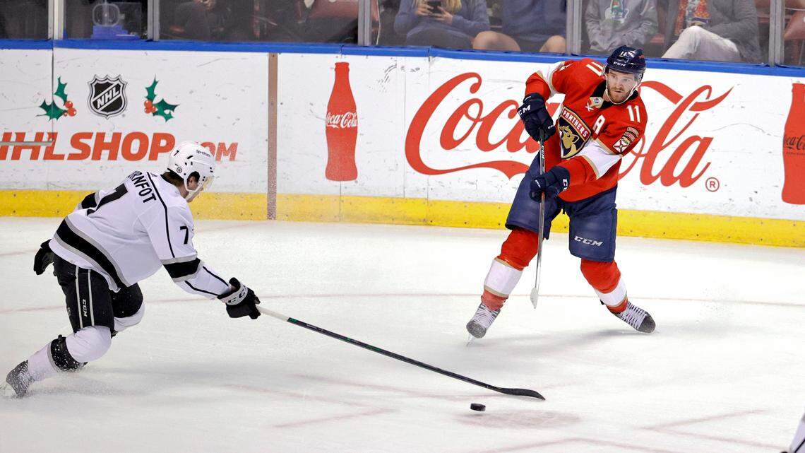 Florida Panthers left wing Jonathan Huberdeau (11) pass the puck against Los Angeles Kings defenseman Tobias Bjornfot (7) during the first period of an NHL game at the FLA Live Arena on Thursday, December 16, 2021 in Sunrise, Fl.