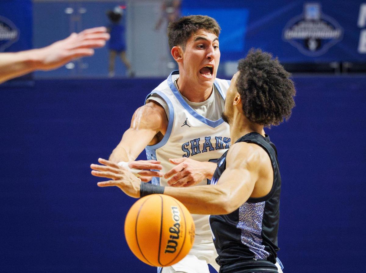 NSU Sharks MJ Iraldi (2) passes the ball around UAH Chargers Auston Leslie(1) during the first half of a NCAA Division II Regional final on Tuesday, March 18, 2025, in the Rick Case Arena at Nova Southeastern University in Davie, Fla. The winner advances to the Elite Eight.