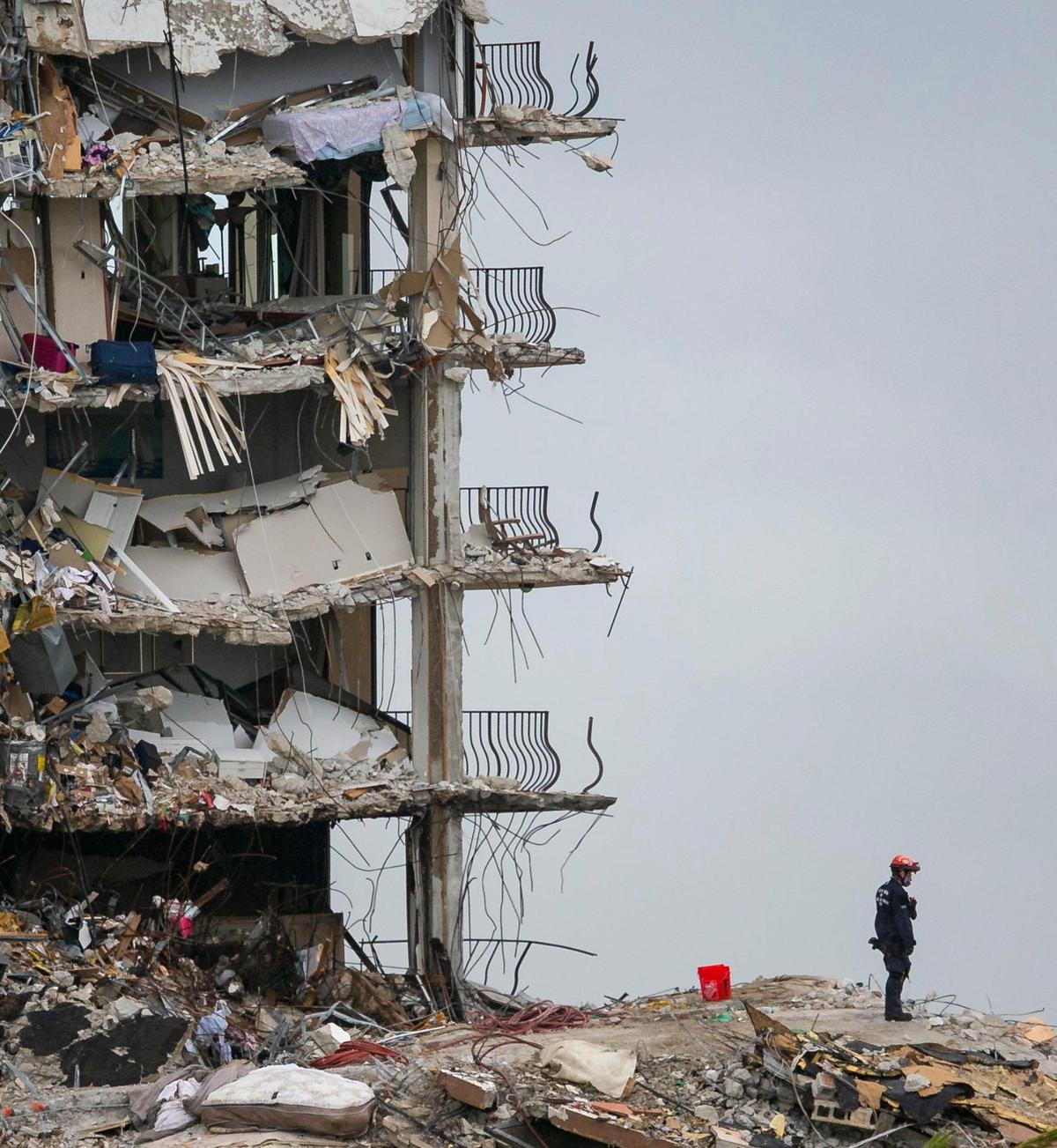 Search and rescue teams comb through rubble at the partially collapsed Champlain Towers South condo building in Surfside on June 28, 2021, four days after the building collapsed.