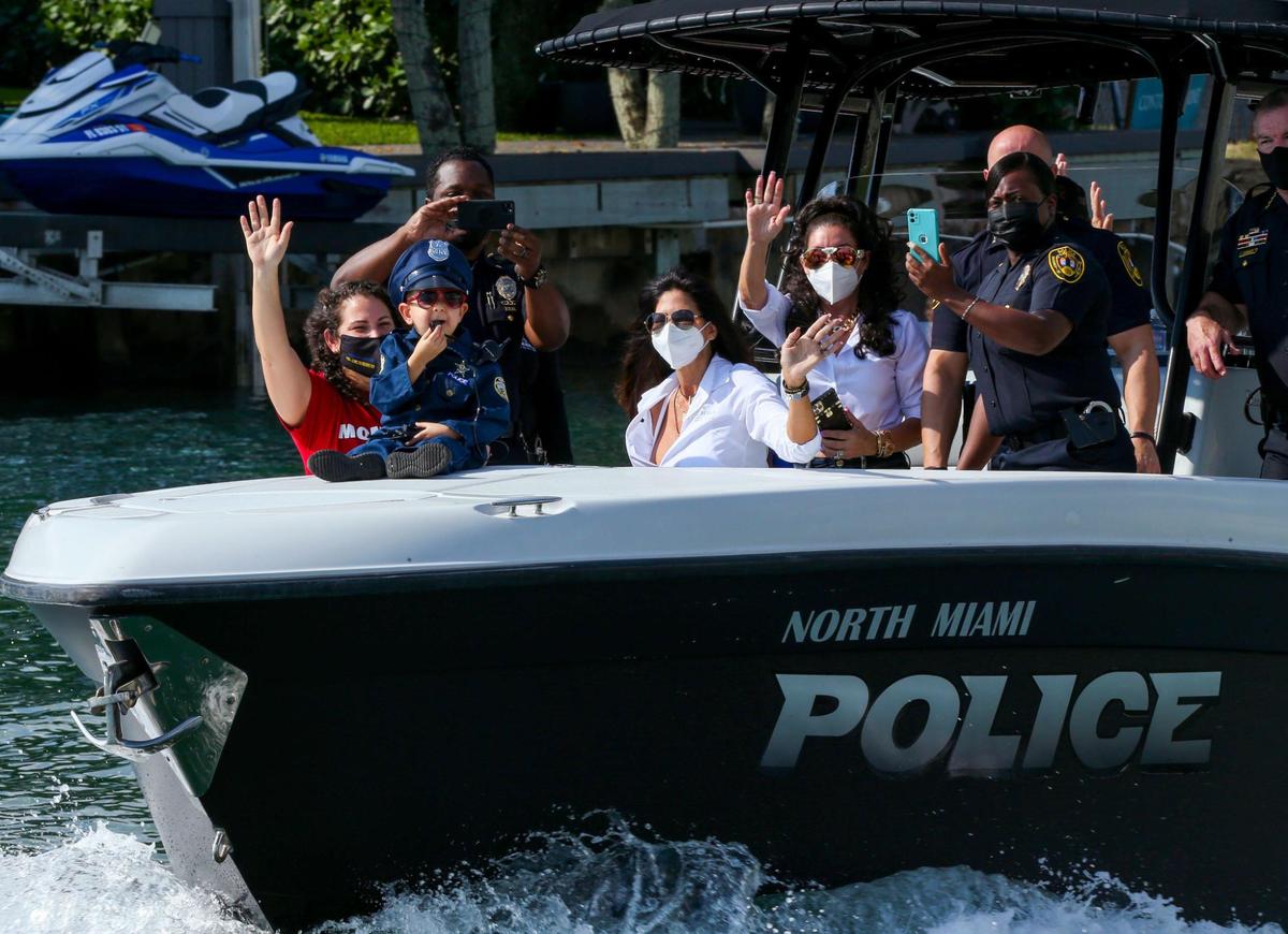 Kayson Roman, 6, who is diagnosed with Stage IV Neuroblastoma, blows his whistle while riding in a police watercraft with family as part of a salute to him on the water on Friday, Jan. 7, 2022. The event was coordinated between North Miami Police and the Mystic Force Foundation. Indian Creek, Florida Fish and Wildlife Conservation Commission, the U.S. Coast Guard, Miami-Dade Fire and Miami Fire set up in formation, giving Kayson a water salute and helicopter flyby.