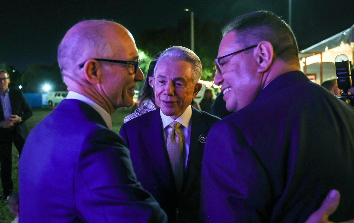 Florida International University President Dr. Kenneth A. Jessell (far left), shares a moment with Benjamín León Jr., center, founder of Leon Medical Centers, and Mario Murgado, president and CEO of Murgado Automotive Group, during the unveiling of architectural renderings CasaCuba, an academic and cultural center showcasing Cuban and Cuban-American heritage to be built on FIU’s main campus.