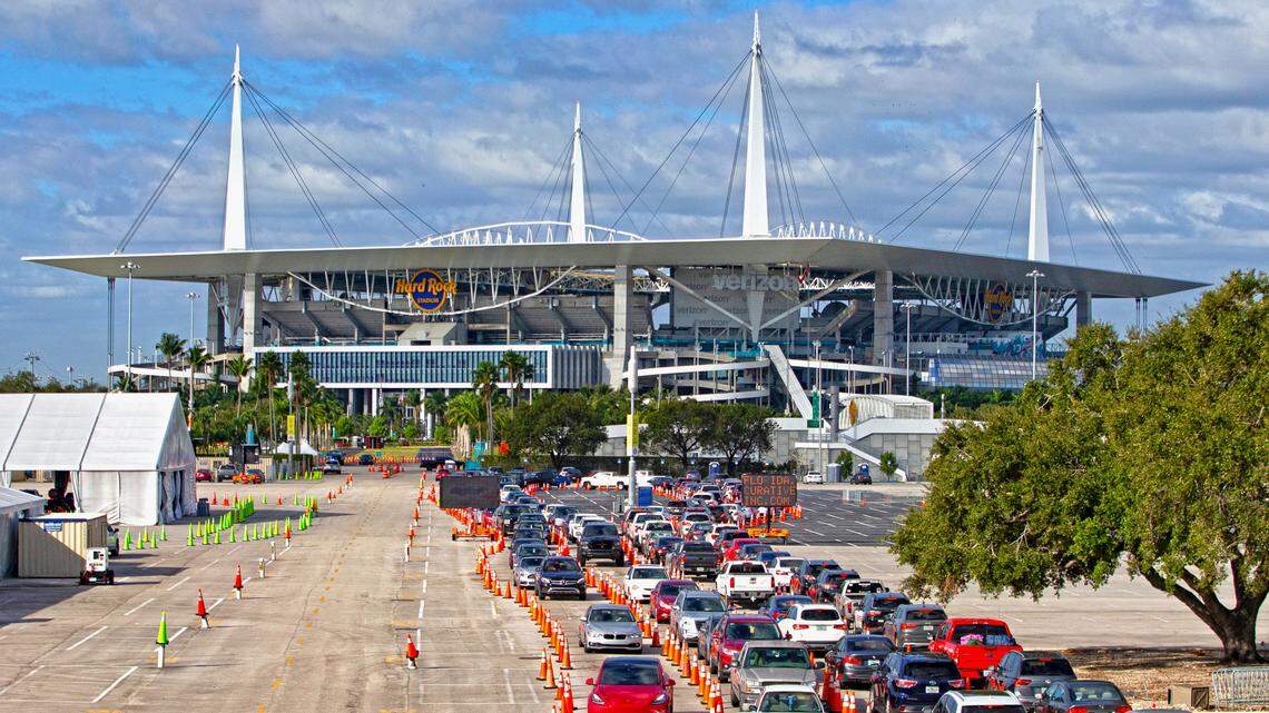 Vehicles line up as healthcare workers check in people being tested at the COVID-19 drive-through testing center at Hard Rock Stadium in Miami Gardens in Dcember 2020. 