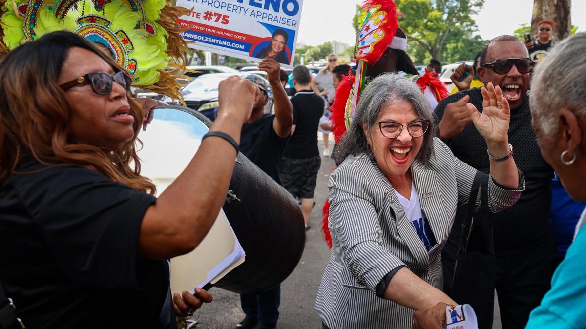 Democratic candidates, Mayor Daniella Levine Cava, right, and unincorporated Miami-Dade voters dance to the sounds of the Bahamian Junkanoo band during a festive visit to the polls at the Joseph Caleb Center during the “Souls to the Polls” event on the last day of early voting on Sunday, November 3, 2024 in Miami, Florida.