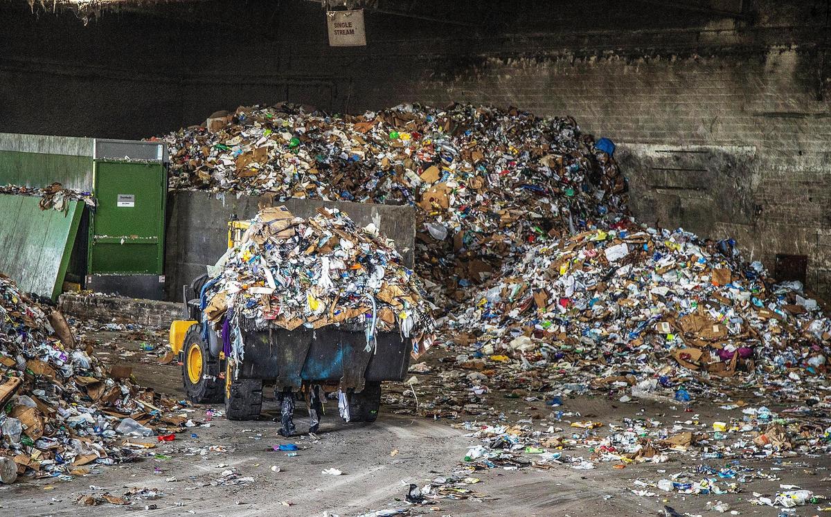 A wheel loader moved a pile of mixed, unsorted recycled materials including plastic, cardboard and paper, at the Waste Management Recycling Plant at 20701 Pembroke Road in Pembroke Pines on April 8, 2022.