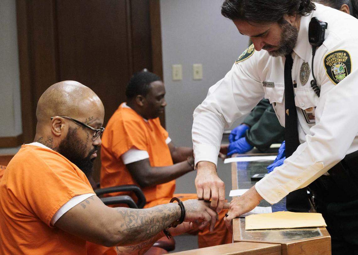 Reginald Louis Jackson, left, and Roderick Martin, accused of 2013 double murder of a church minister and her grandson in her Miami Gardens home, sign their plea deals after pleading guilty on Wednesday, April 29, 2026, inside the Richard E. Gerstein Justice Building in downtown Miami, Fla.