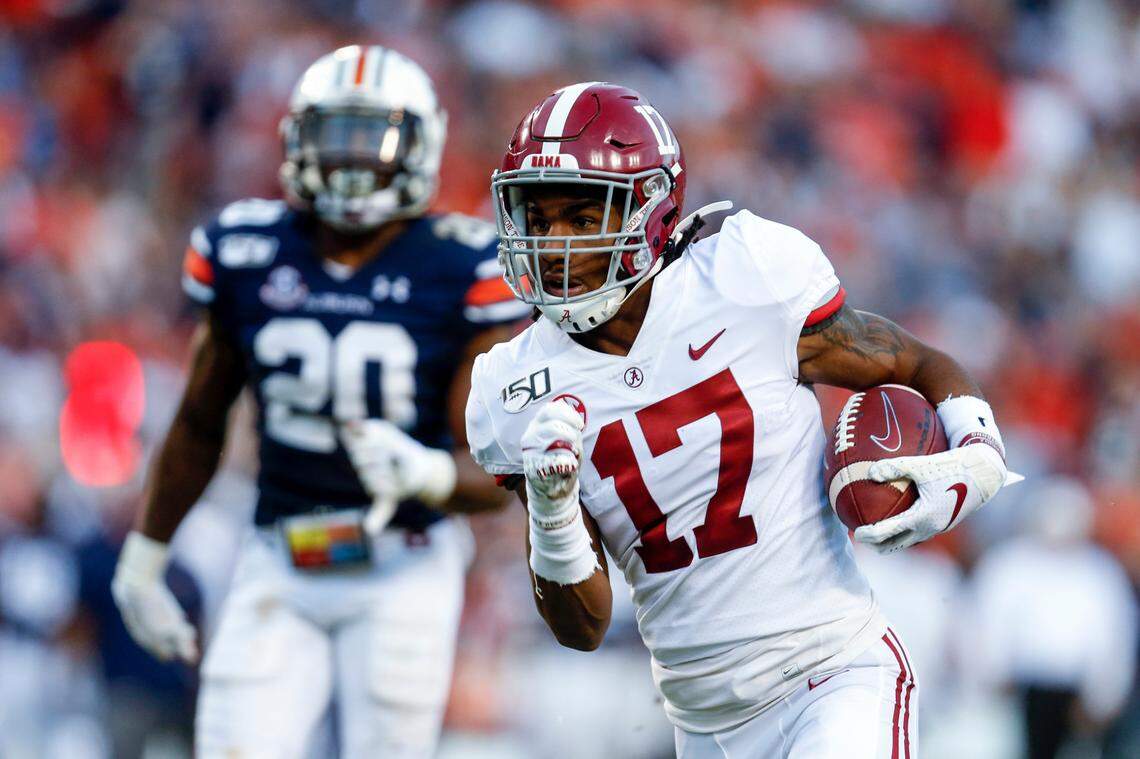FILE - In this Saturday, Nov. 30, 2019 file photo, Alabama wide receiver Jaylen Waddle (17) carries the ball in for a touchdown after a reception in the first half of an NCAA college football game against Auburn in Auburn, Ala. The New York Giants spent the two months leading up to the draft in a somewhat unexpected dip into the free agency market that filled holes at wide receiver and cornerback, and narrowed their positional needs.