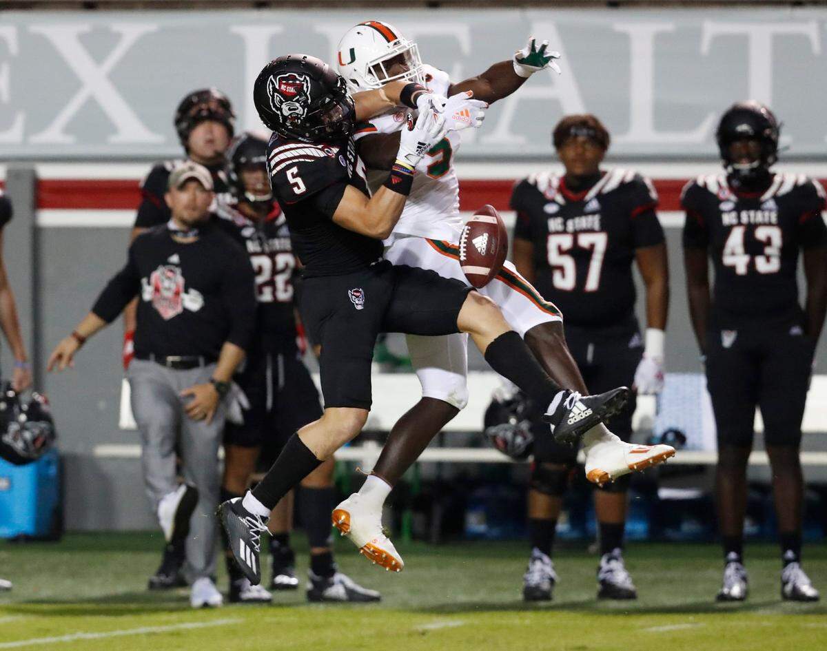 Miami safety Amari Carter (5) breaks up a pass intended for N.C. State wide receiver Thayer Thomas (5) during the first half of N.C. States game against Miami at Carter-Finley Stadium in Raleigh, N.C., Friday, Nov. 6, 2020.