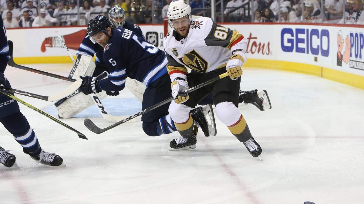 Jonathan Marchessault #81 of the Vegas Golden Knights battles for the puck with Dmitry Kulikov #5 of the Winnipeg Jets during the third period in Game Five Sunday.