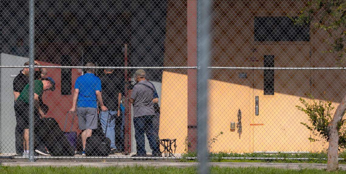 Parkland, Florida, August 4, 2023 - Workers carry equipment inside the freshman building at Marjorie Stoneman Douglas High School where Nikolas Cruz killed 17 people 5 years ago. They were preparing for a reenactment of the shooting featuring live gunfire. The reenactment is part of a lawsuit against the school’s former resource officer Scot Peterson.