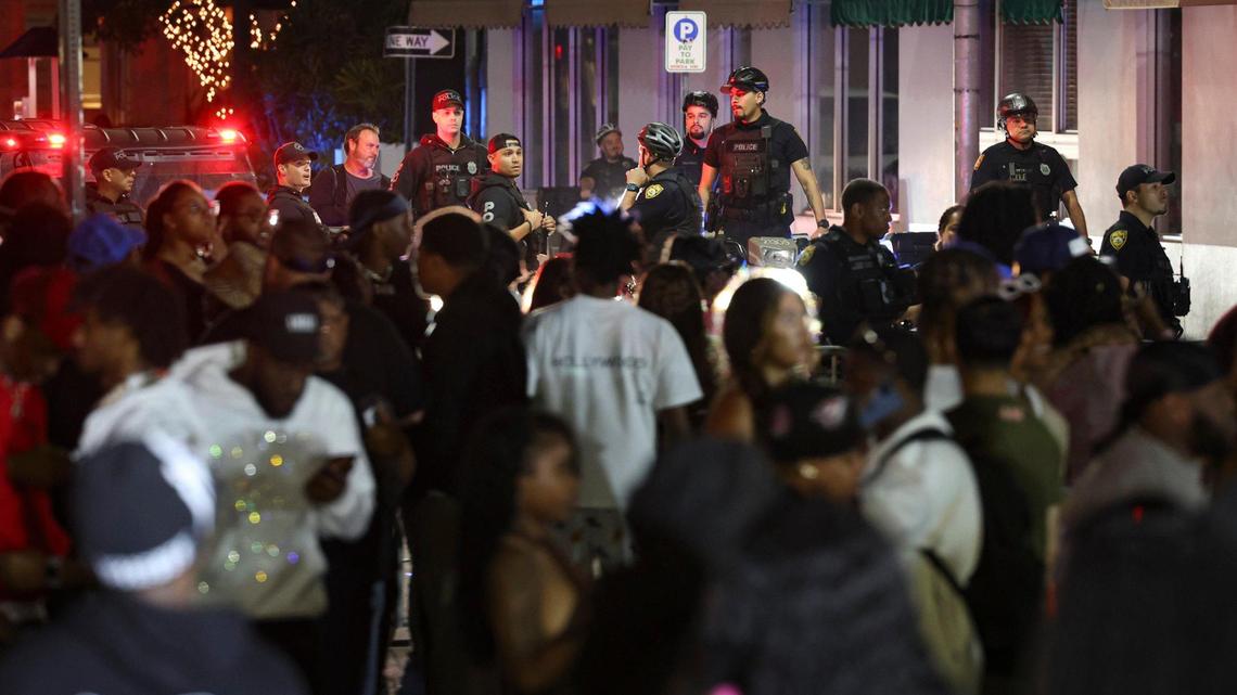 Police begin to clear people off of Eighth Street and Ocean Drive to prepare for the midnight curfew that was imposed on Sunday, March 19, 2023, in Miami Beach.