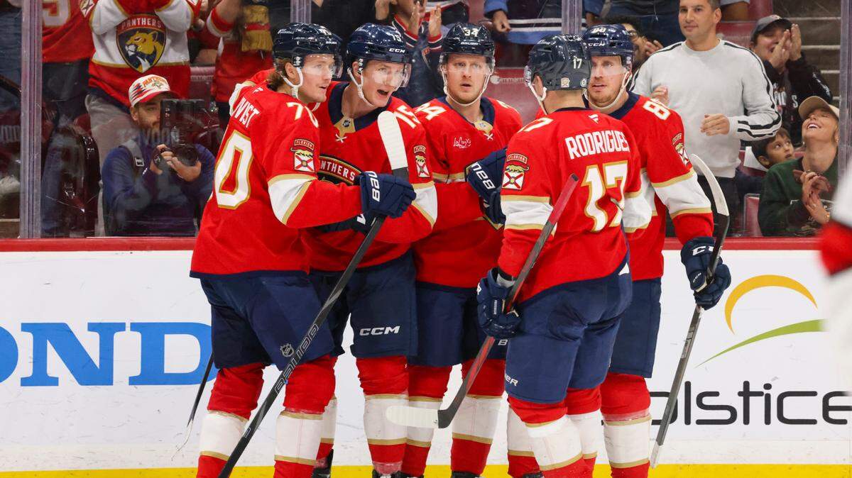 Florida Panthers center Anton Lundell (15), second from the left, and his teammates celebrate his goal against the Carolina Hurricanes during the second period of a game on Thursday, Jan. 2, 2025, at Amerant Bank Arena in Sunrise, Fla.