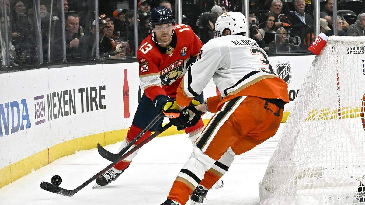 Florida Panthers center Sam Reinhart, left, passes the puck past Anaheim Ducks defenseman John Klingberg during the second period of an NHL hockey game in Anaheim, Calif., Sunday, Nov. 6, 2022. (AP Photo/Alex Gallardo)