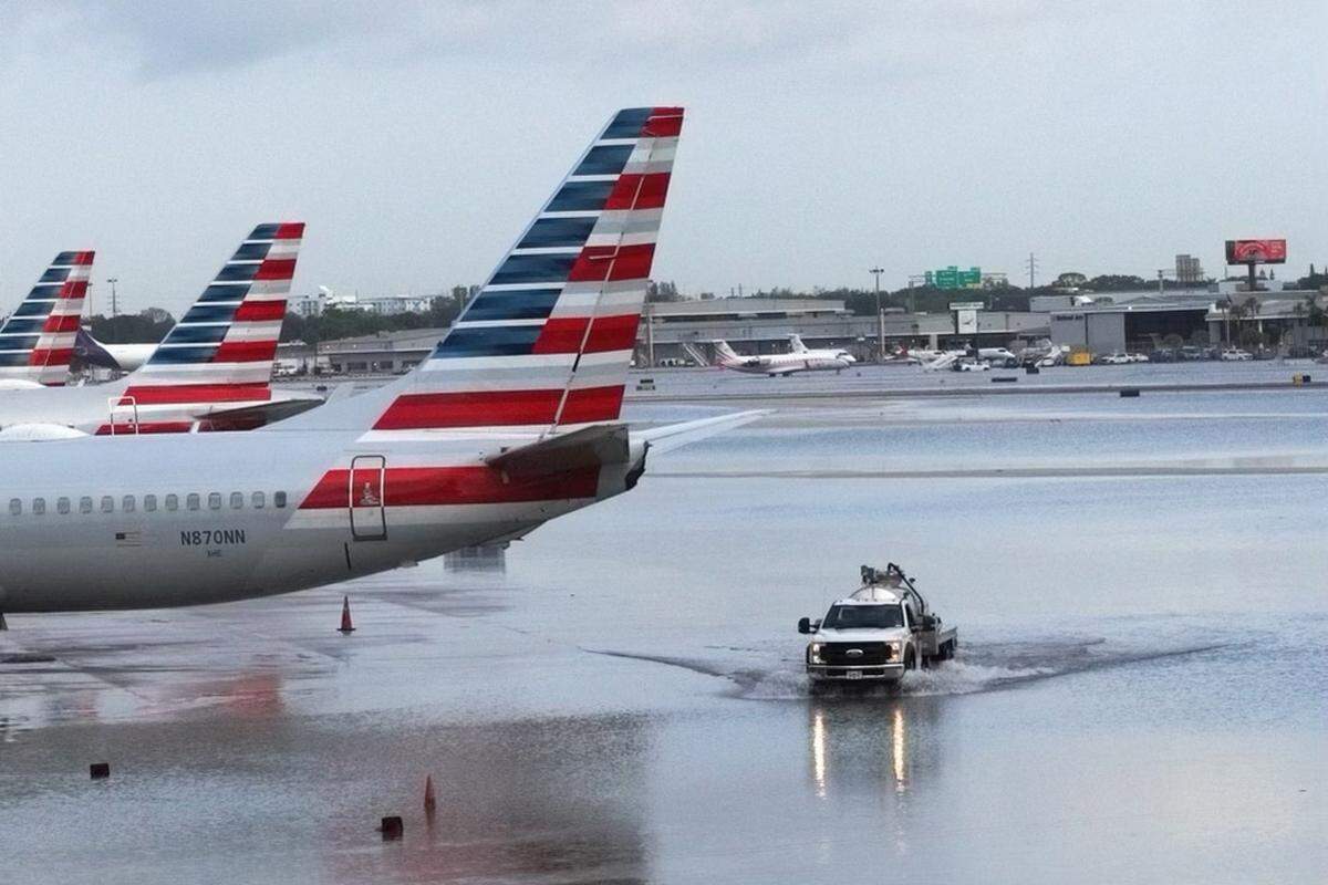 A truck drives on the flooded tarmac around Terminal 3 at the Fort Lauderdale-Hollywood International Airport on Thursday, April 13, 2023.
