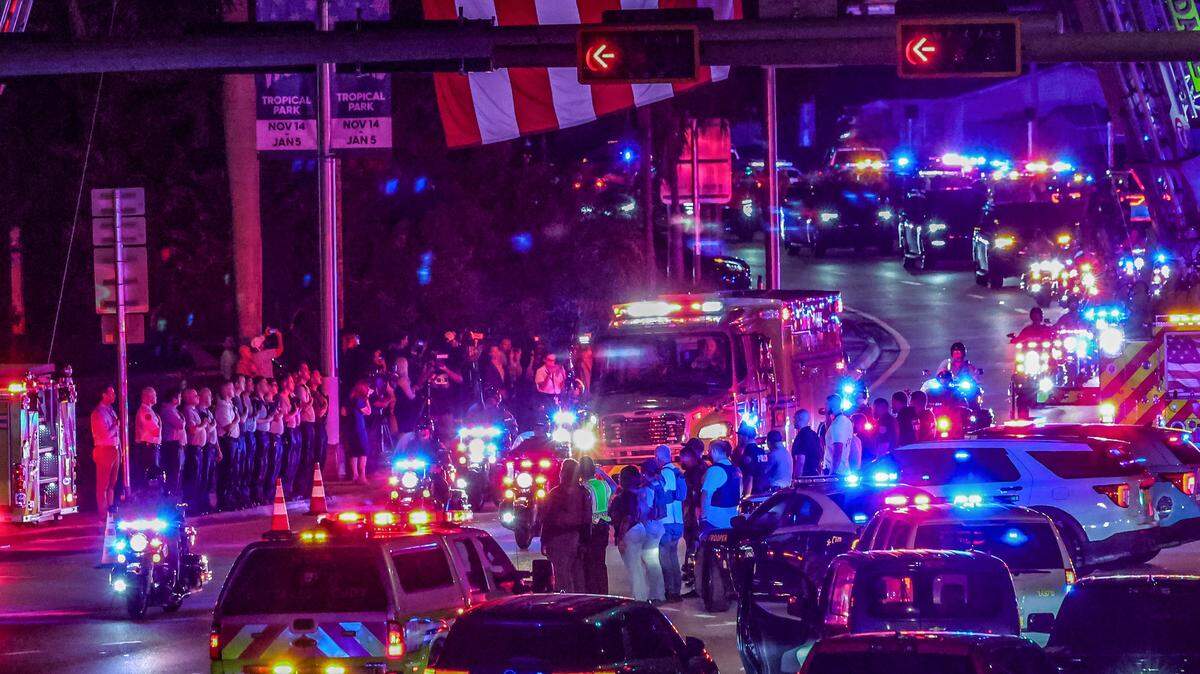 Law enforcement officers from different cities and members of the Miami-Dade Fire fighters paid tribute outside of the HCA Florida Kendall Hospital as the fire rescue unit carrying the body of Miami-Dade Deputy Devin Jaramillo who was ambushed as he responded to a traffic accident and was shot to death, on Friday, Nov. 7, 2025.
