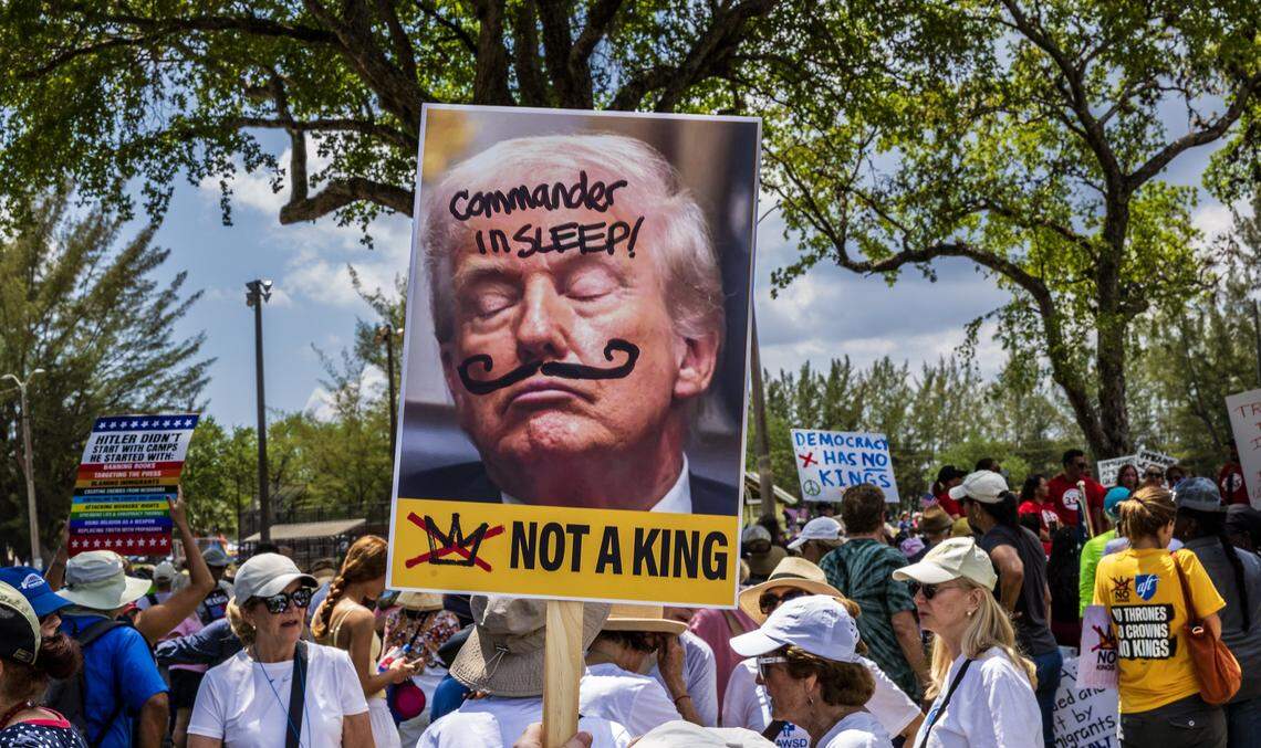 Protesters show their signs and slogans at Tropical Park on Saturday March 28, 2026.