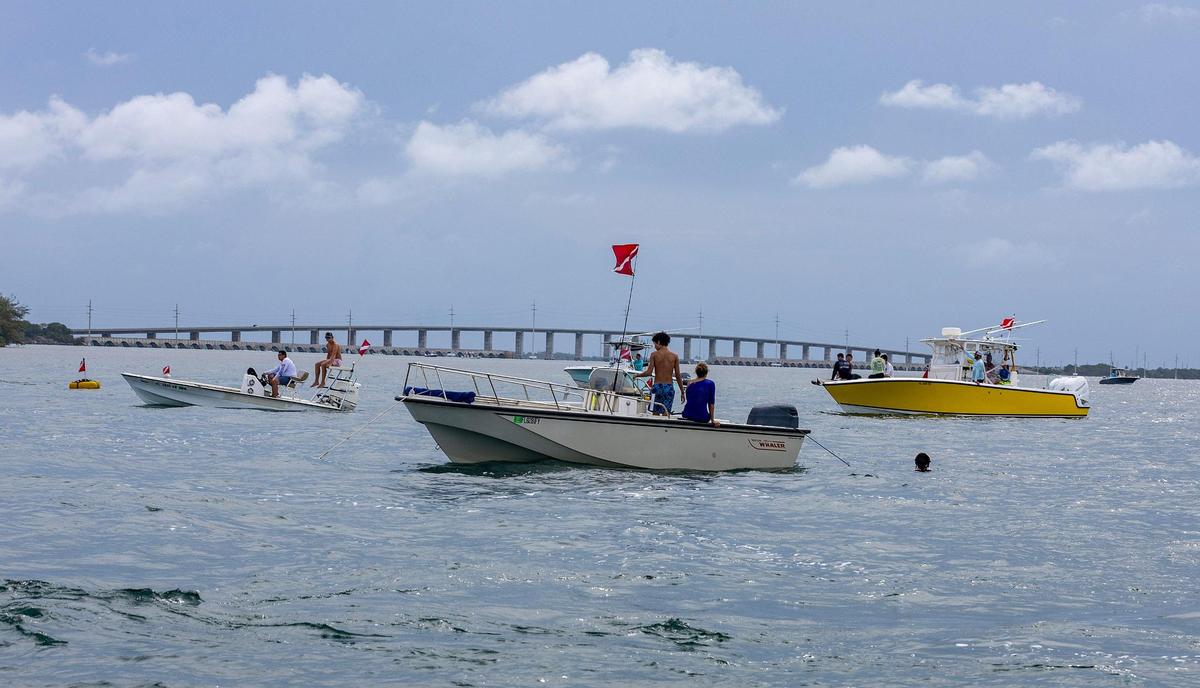 View of several boats staying close to divers in the water attempting to capture some Florida spiny lobsters during the first day of lobster miniseason in the Florida Keys on Wednesday, July 26, 2023.