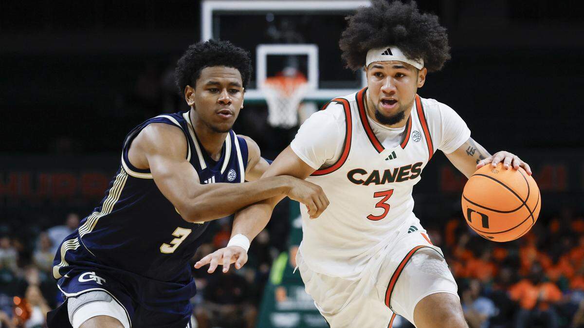 Miami Hurricanes guard Tre Donaldson (3) drives the ball as Georgia Tech Yellow Jackets guard Jaeden Mustaf (3) defends during the second half of an NCAA basketball game at the Watsco Center on the University of Miami Campus on Saturday, January 10, 2026 in Coral Gables, Florida.