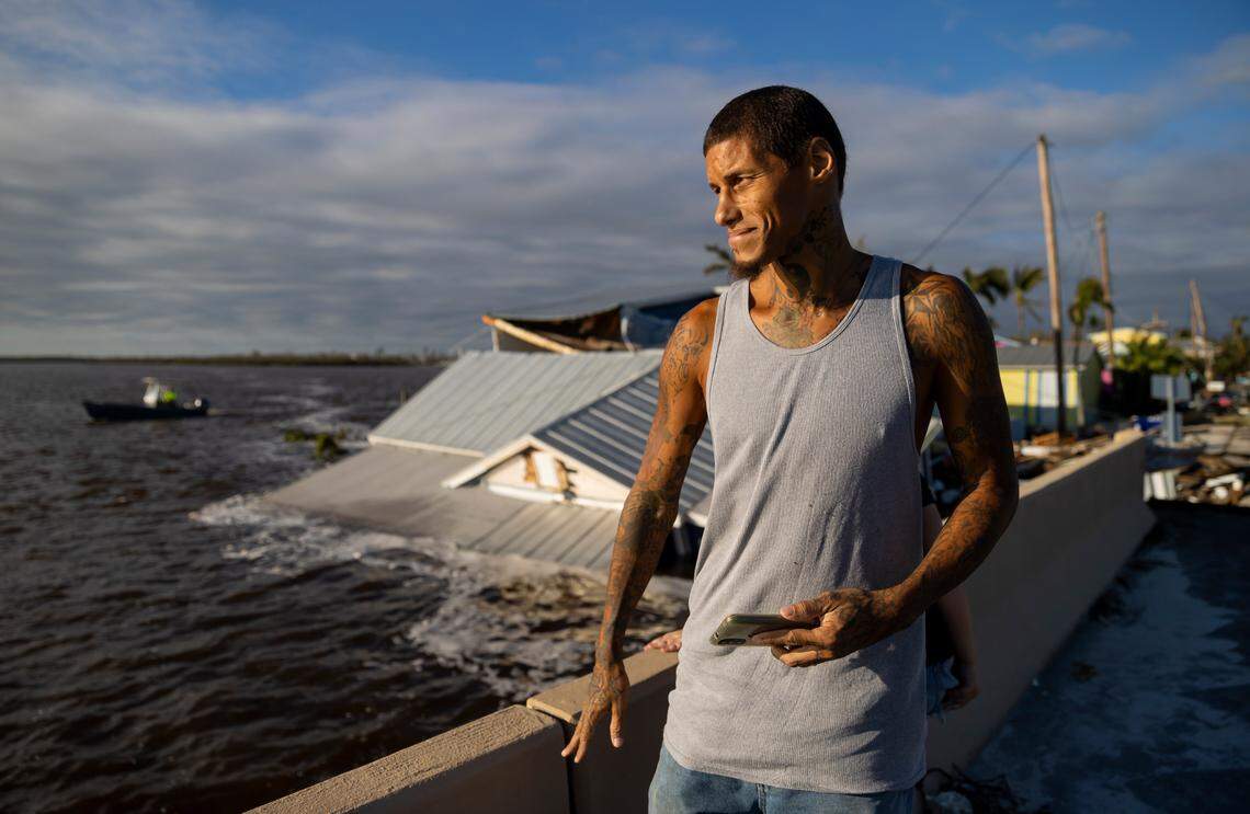 Jason Diamond, 41, surveys damage on Pine Island Road on Thursday, Sept. 29, 2022, in Matlacha, Fla. Hurricane Ian made landfall on the coast of Southwest Florida as a Category 4 storm Tuesday afternoon leaving areas affected with flooded streets, downed trees and scattered debris.