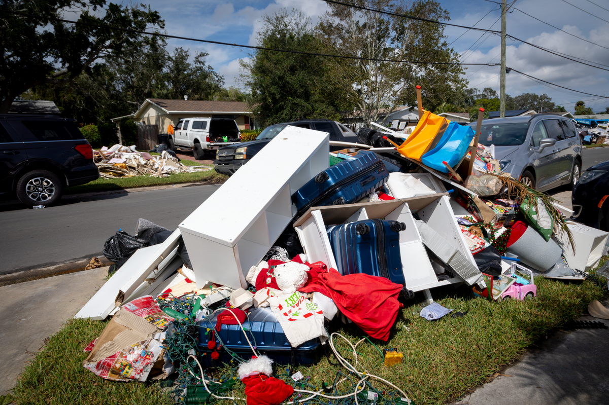 The Martins put their soaked belongings out on the curb to be picked up with the trash. Before Hurricane Helene, they moved valuables to storage, but the flood ruined their Christmas decorations and some children’s toys.