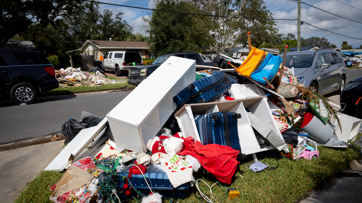 The Martins put their soaked belongings out on the curb to be picked up with the trash. Before Hurricane Helene, they moved valuables to storage, but the flood ruined their Christmas decorations and some children’s toys.