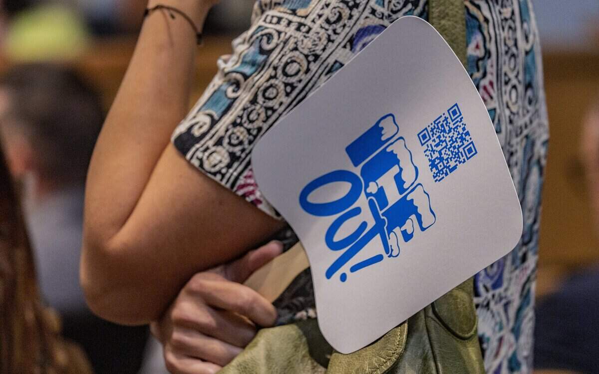 A resident displays an anti ICE sign before speaking against the 287(g) agreement with ICE that the City of Miami commission voted in favor to enter into last year, during a Miami City Commission meeting, at City Hall, on Thursday June 25, 2026.