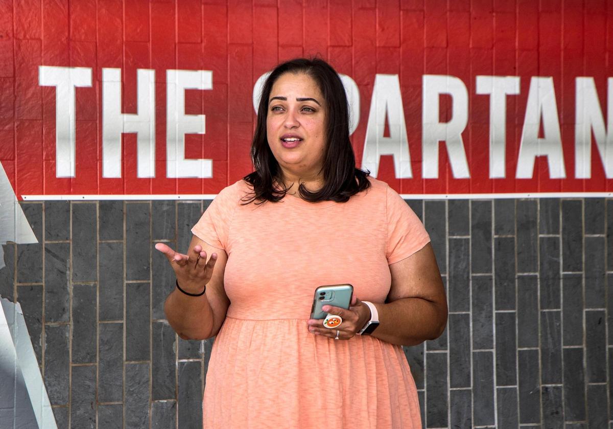 Jennifer Desa, a journalism and social studies teacher at Miami Southridge High, says she’s concerned that Florida’s new education laws can embolden parents, which can potentially impact the learning environment. She posed in front of her school on Friday, Aug.12, 2022.